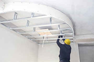 Precision measurement, frame setup, panel fitting, and seamless integration for a polished ceiling finish.